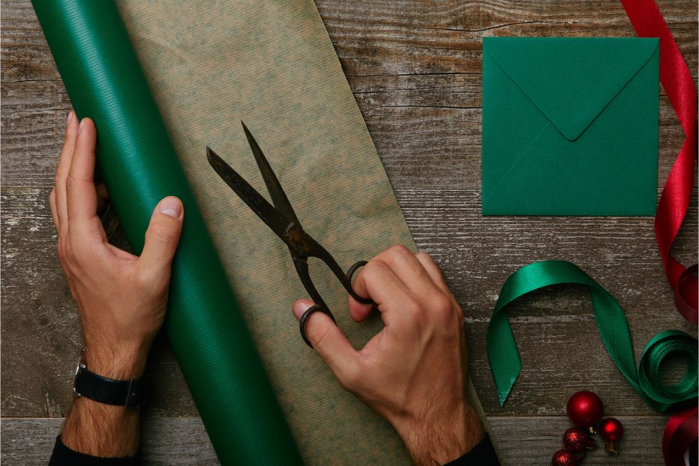man with scissors, wrapping paper for gift wrapping 